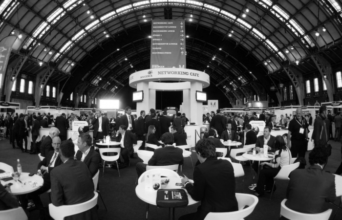 Stands, chairs, tables, people and televisions at Soccerex week